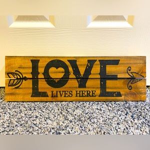 “Love lives here” wooden decor sign